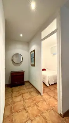 a living room with a couch and a flat screen tv at Cozy Ploblesec Apartment in Barcelona