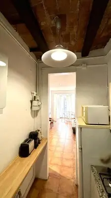 a white table and chairs in a living room at Cozy Ploblesec Apartment in Barcelona