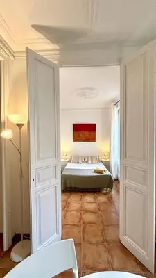 a living room with a couch and a table at Cozy Ploblesec Apartment in Barcelona