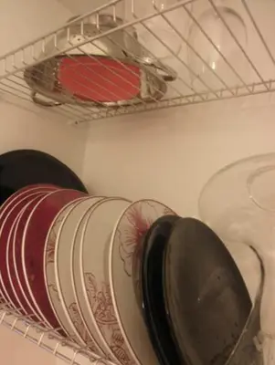 a group of plates and bowls on a shelf at Piquer con Terraza in Barcelona
