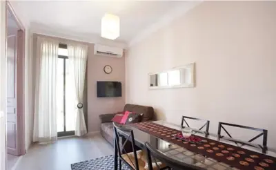 a living room with a table and a couch at Piquer con Terraza in Barcelona
