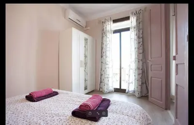 a bedroom with two pillows on a bed with a window at Piquer con Terraza in Barcelona