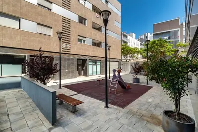 a woman on a ladder in a courtyard in a building at MERCE APARTMENT FORUM BARCELONA in Sant Adria de Besos