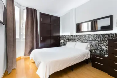 a bedroom with a bed and a dresser and a tv at The Best Barcelona in Barcelona