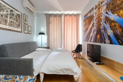 a bedroom with a bed and a flat screen tv at The Best Barcelona in Barcelona
