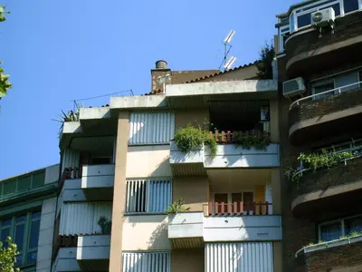 an apartment building with potted plants on the balconies at The Best Barcelona in Barcelona