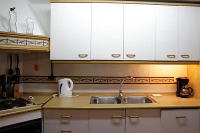 a kitchen with white cabinets and a sink at Quiet apartment! Sagrada Familia! in Barcelona