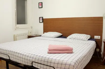 a pink towel sitting on a bed in a bedroom at Quiet apartment! Sagrada Familia! in Barcelona