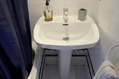 a white sink in a bathroom with a shower at Quiet apartment! Sagrada Familia! in Barcelona