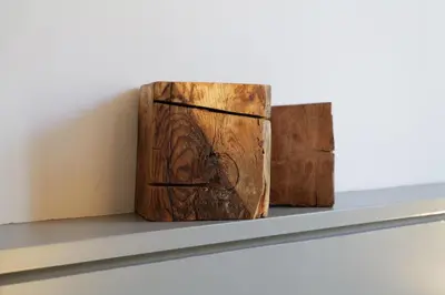 two wooden books sitting on a shelf at Hostal Porxos Garden in Barcelona
