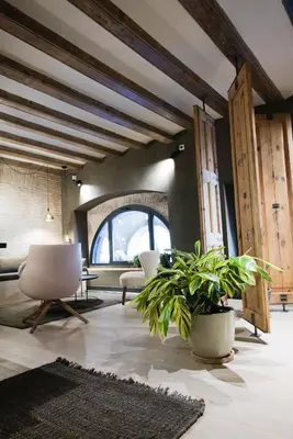 a living room with a large window and a plant at Hostal Porxos Garden in Barcelona