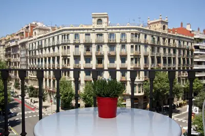 a potted plant sitting on a table in front of a building at Bruc & Bruc in Barcelona