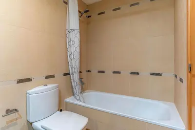 a bathroom with a toilet and a bath tub at 4207 - AB Sant Adria de Besos in Sant Adria de Besos