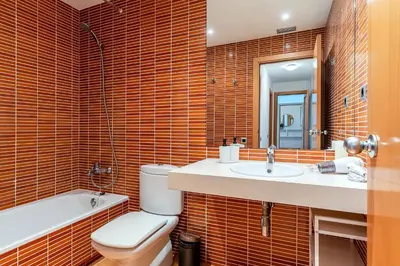 a bathroom with a toilet and a sink and a mirror at 4207 - AB Sant Adria de Besos in Sant Adria de Besos