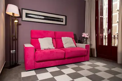 a pink couch sitting in a living room at Autèntic Eixample Barcelona in Barcelona