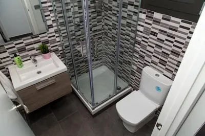 a bathroom with a shower and a toilet and a sink at Autèntic Eixample Barcelona in Barcelona