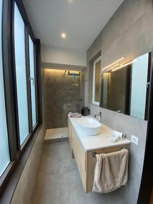 a bathroom with a sink and a mirror at Spatious luxe apartment Paseo de Gracia Diagonal in Barcelona