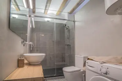 a bathroom with a glass shower and a toilet at Welcomy Born in Barcelona