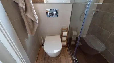 a small bathroom with a toilet and a shower at Welcomy Poblenou II in Barcelona