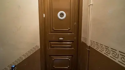 a brown door with a camera on top of it at Welcomy Poblenou II in Barcelona