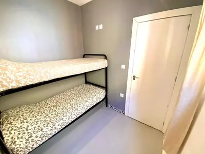 a small room with two bunk beds and a door at Apartamento de 3 habitaciones en Sants a 2`del metro Badal P9 in Barcelona