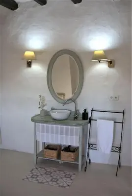 a bathroom with a sink and a mirror on a wall at Can Vidal in Subirats