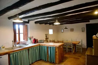 a kitchen with an island in the middle of a room at Can Vidal in Subirats