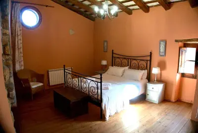 a bedroom with a large bed and a window at Can Vidal in Subirats