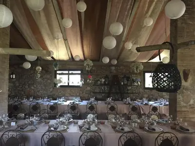 a banquet hall with tables and chairs in a room at Can Vidal in Subirats