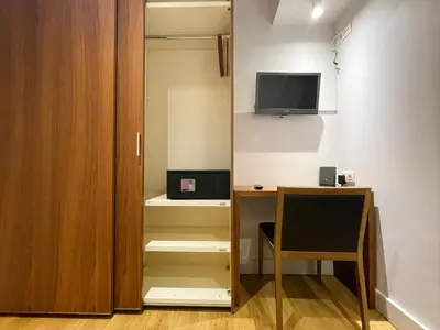 a room with a desk and a tv on the wall at Boutique Pare Lainez- 2 BR Sagrada Famlia with balcony in Barcelona