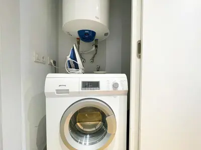 a white washer and dryer in a room at Boutique Pare Lainez- 2 BR Sagrada Famlia with balcony in Barcelona