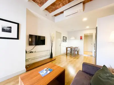 a living room with a couch and a table at Boutique Pare Lainez- 2 BR Sagrada Famlia with balcony in Barcelona