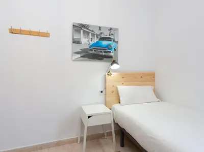 a bedroom with a bed and a blue car on the wall at Centric Sagrada Familia Apartments in Barcelona