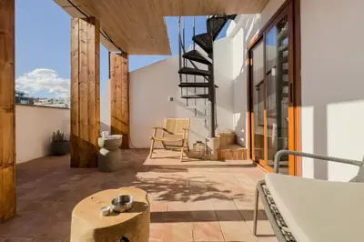 a room with a balcony with a view of a building at Boutique Design Apartments & Studios in Barcelona