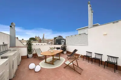 a pile of pillows sitting on top of a bed at Boutique Design Apartments & Studios in Barcelona