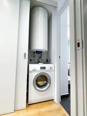 a white washer and dryer in a room at Boutique Pare Lainez in Barcelona