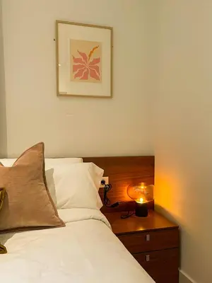 a bedroom with a bed with a candle on a table at Boutique Pare Lainez in Barcelona