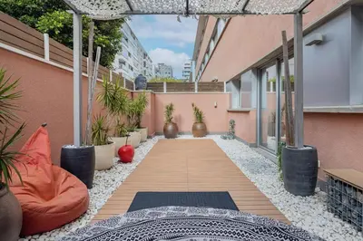 an internal courtyard of a building with plants and mats at Pool LUXURY 2 Bedrooms - 2 Terraces - Parking - Long Term in Barcelona