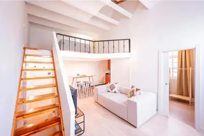 a living room with a loft bed and a staircase at Sweett - Ethnic Eixample in Barcelona
