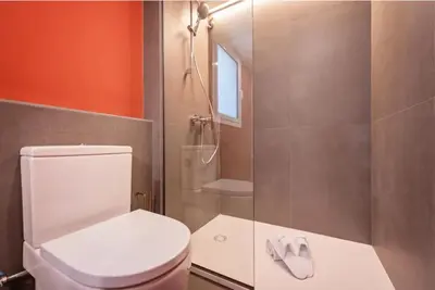 a bathroom with a white toilet and a shower at Sweett - Ethnic Eixample in Barcelona