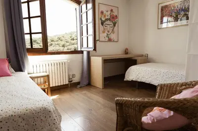 a small room with two beds and a window at Villa Alella, 5 bedrooms & pool in Alella