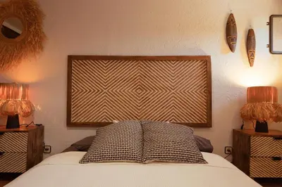 a bedroom with a bed with two lamps and a window at Villa Alella, 5 bedrooms & pool in Alella