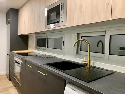 a kitchen with a sink and a microwave at Dolce Terrassa 25 min Barcelona and Beach in Terrassa