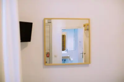 a mirror on a wall in a room at Hostal Eixample in Barcelona