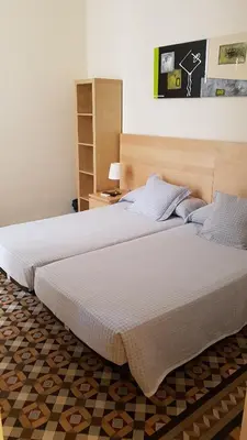 two beds in a hotel room with at Hostal Eixample in Barcelona