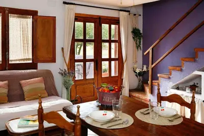 a living room with a table and a couch at La Ginesta Rural, cerca de Sitges in Canyelles