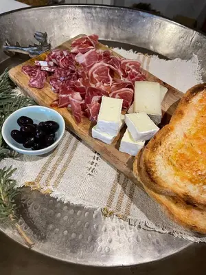a pizza with meat and cheese on a plate with bread at L'ESTABLE DE CAN TABERNER in Bigues i Riells