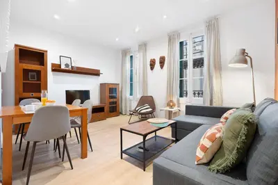a living room with a couch and a dining room at Lodging Apartments Villarroel apartment in Barcelona