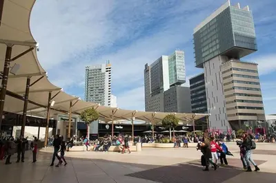 a group of people walking around a plaza in a city at Ático cerca Playa y centro a 10 min. in Sant Adria de Besos
