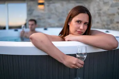 a woman sitting in a bath tub with a glass of wine at jacuzzi privado con vistas increíbles el Raco d Artes in Artés